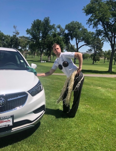 dentist posing by a car that you can win for dental hygiene